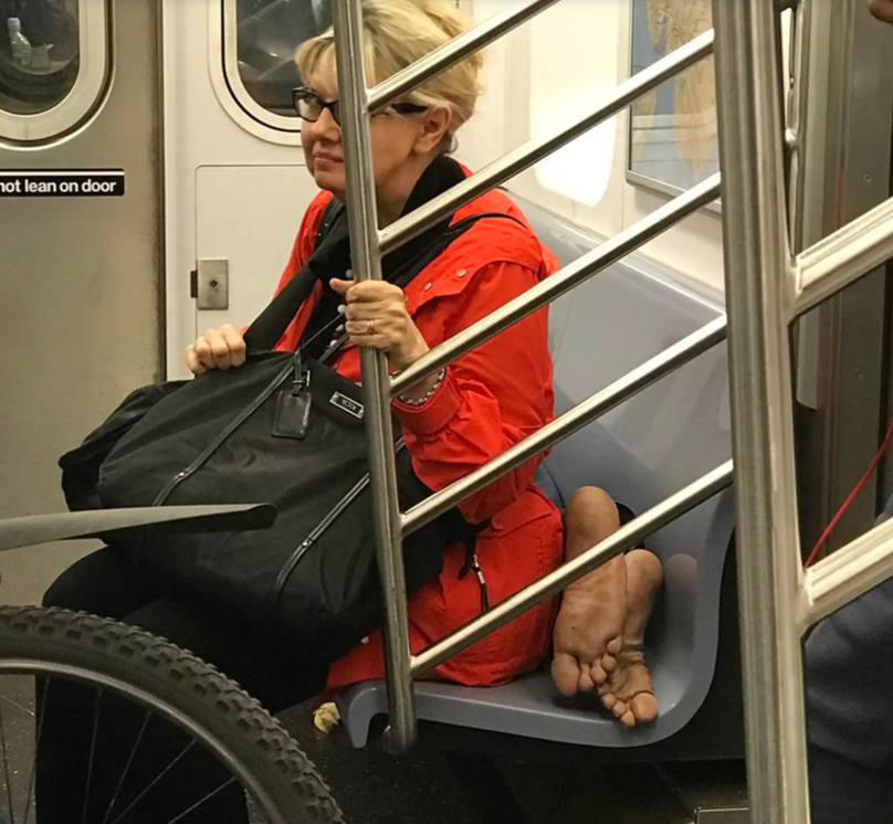 woman sitting on man subway